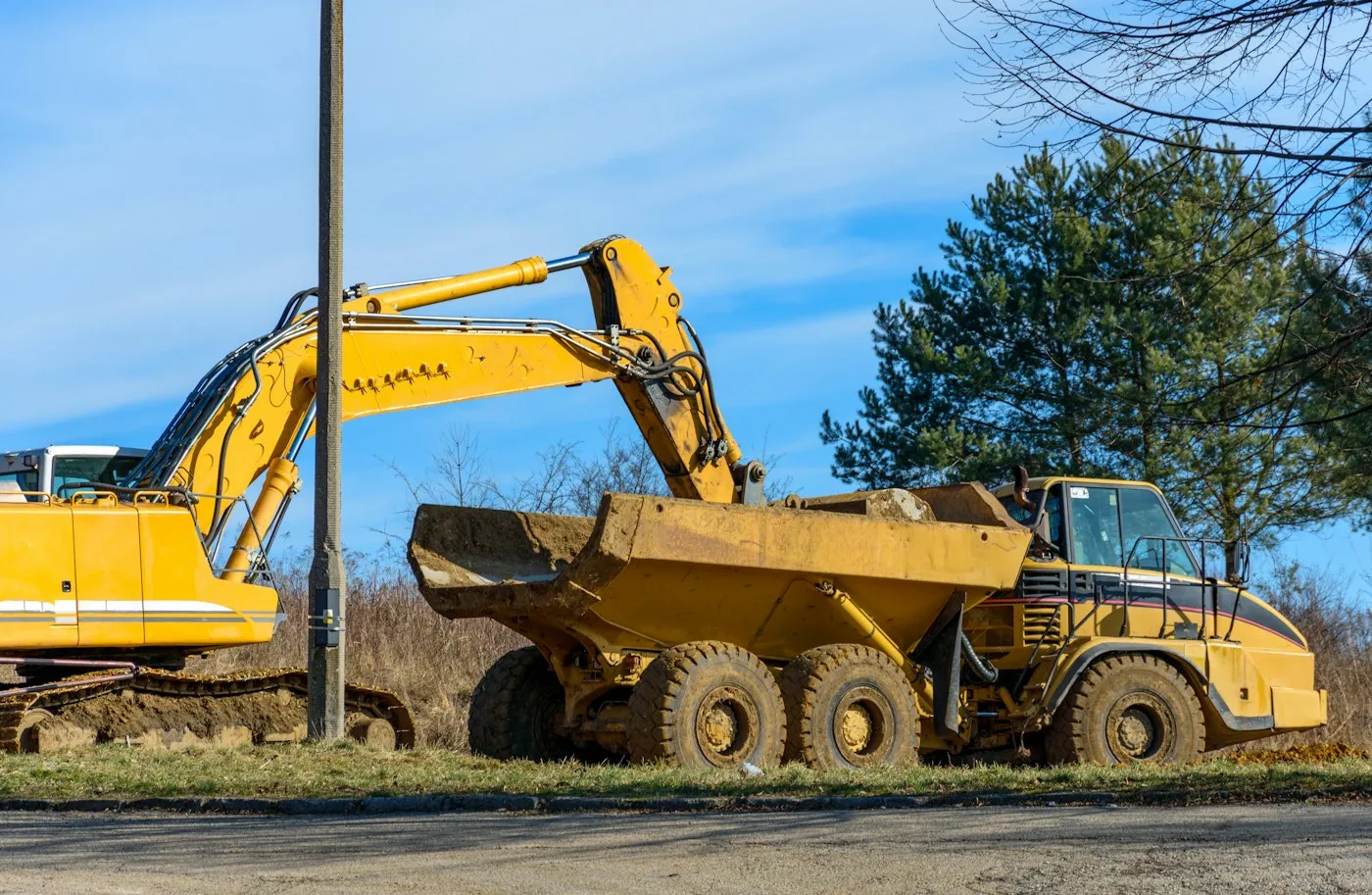 Tracked excavator beside a haul truck