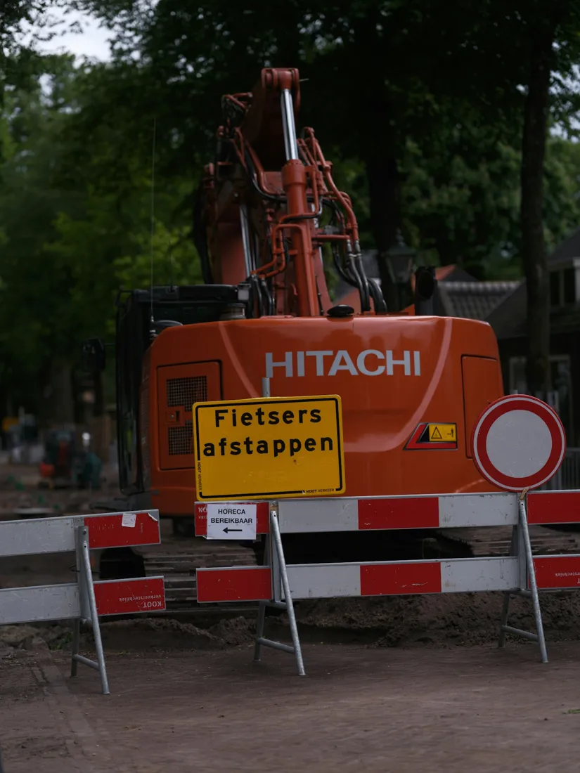 Rear view of an excavator beside a roadway